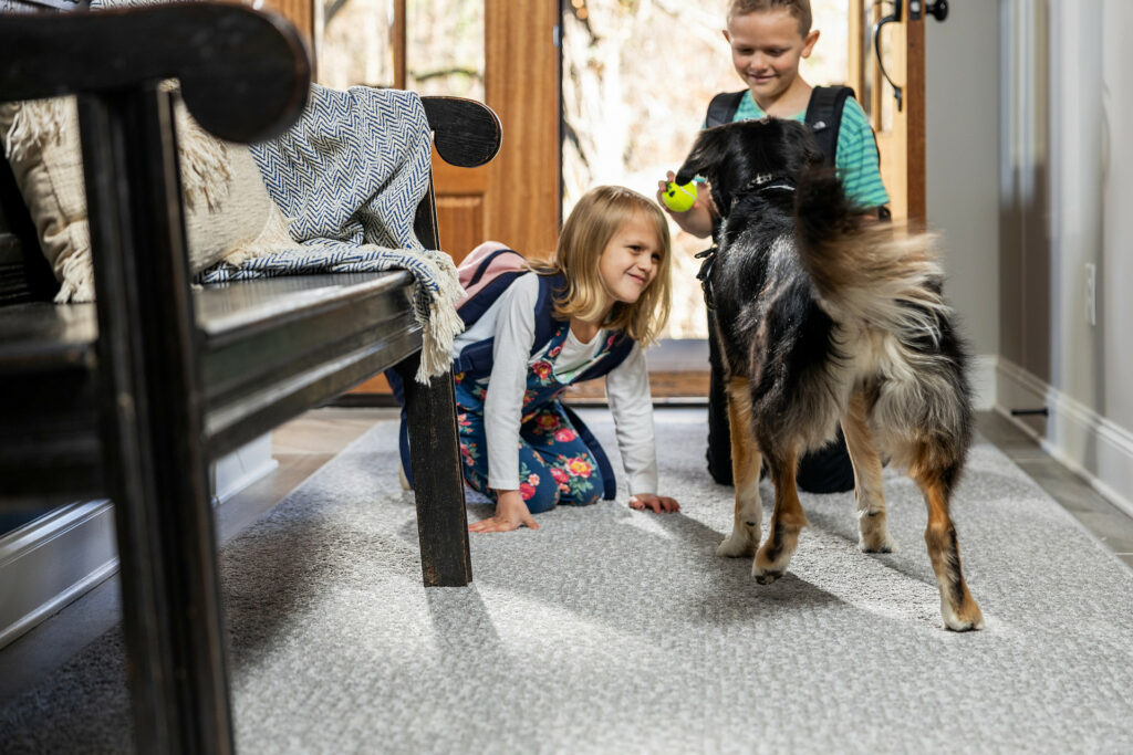 Kids plying with dog on carpet flooring | Bowling Carpet