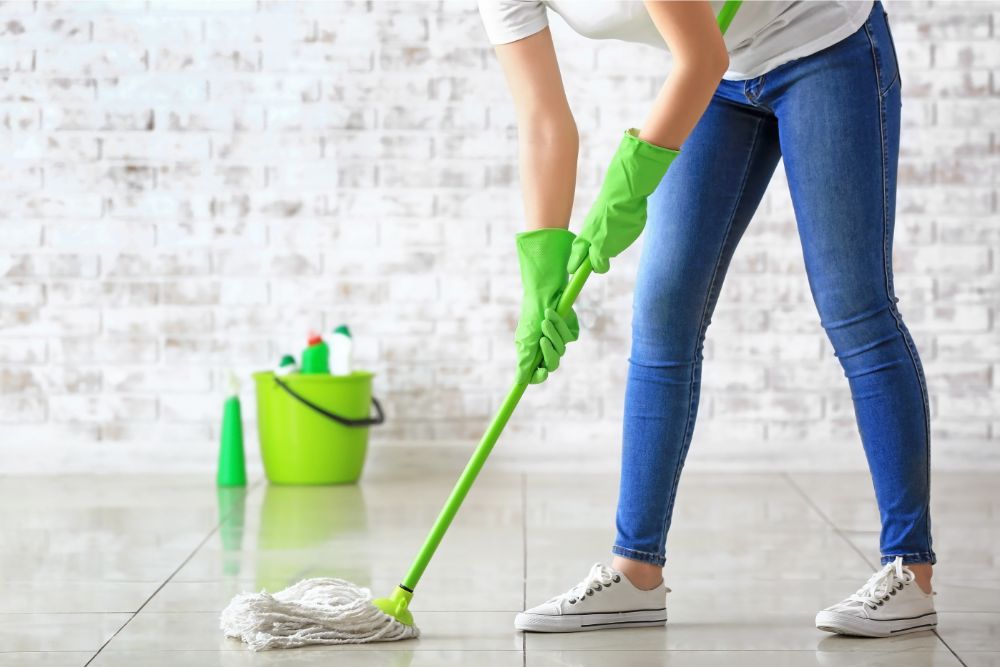 Woman cleaning tile floor